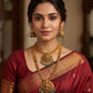 Woman wearing traditional jewelry and a saree with a blurred background