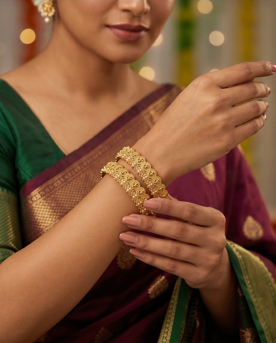 Woman wearing gold jewelry with a blurred background