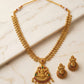 Gold necklace and earrings on a marble surface