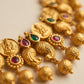 Gold necklace with gemstones on a beige background