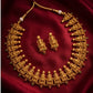 Gold necklace and earrings on a red fabric background